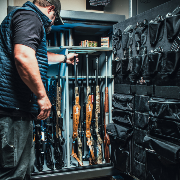 Man grabbing gun from safe.
